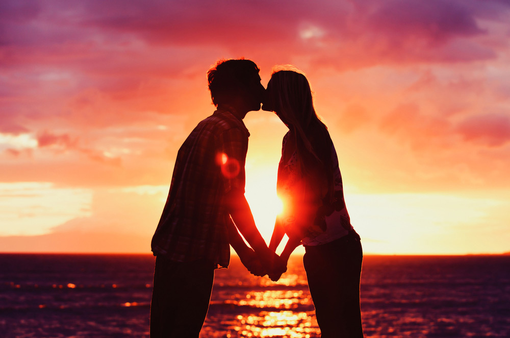 couple kissing at sunset