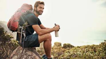 Man taking a pause during a hike outdoors