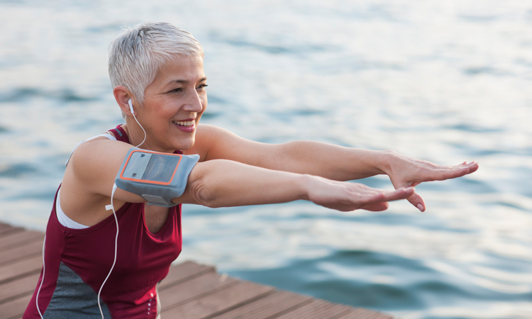 woman doing exercise by water